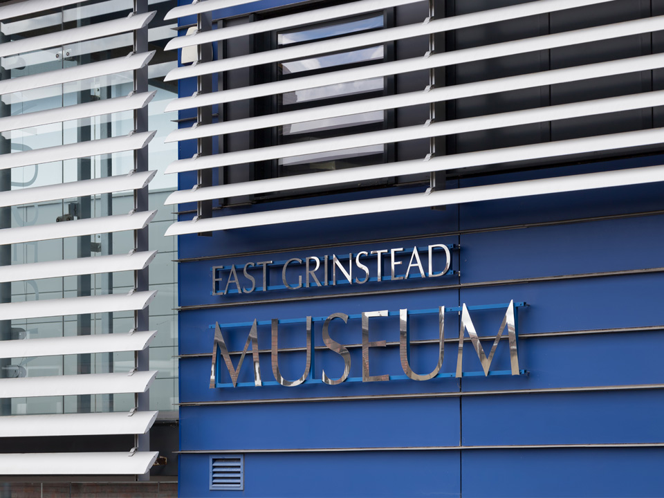 East Grinstead Museum signage on a modern blue facade
